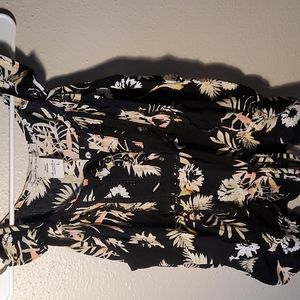 Medium black blouse with colorful leaves.